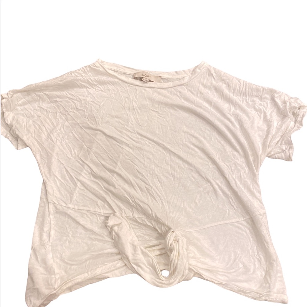 A little wrinkly. White, short sleeve, thin t-shirt